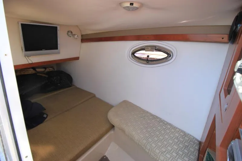 Slide: The Image of 2008 Four Winns 310 Horizon cabin interior with TV and porthole window. - 19