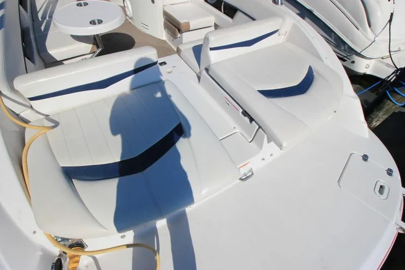 Slide: The Image of 2008 Four Winns 310 Horizon boat interior with white seating and table. - 2