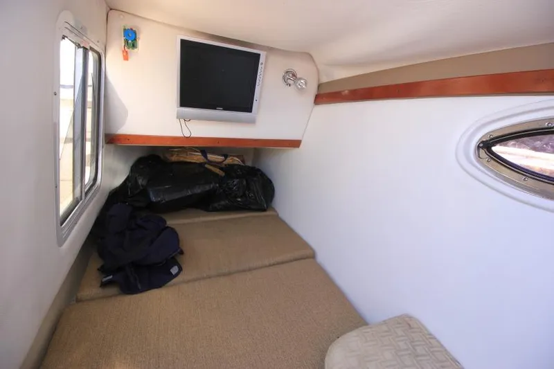 Slide: The Image of 2008 Four Winns 310 Horizon cabin interior with TV and window. - 20