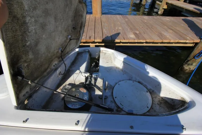 Slide: The Image of Open storage compartment on 2008 Four Winns 310 Horizon boat near wooden dock. - 24
