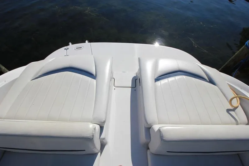 Slide: The Image of 2008 Four Winns 310 Horizon boat with white cushioned seating, docked by the water. - 3