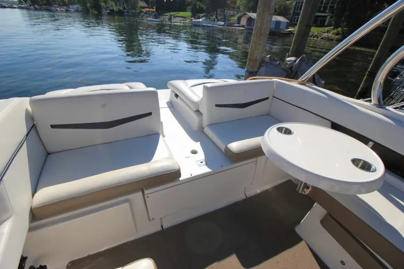 Slide: The Image of 2008 Four Winns 310 Horizon boat interior with seating and table on a sunny day. - 5