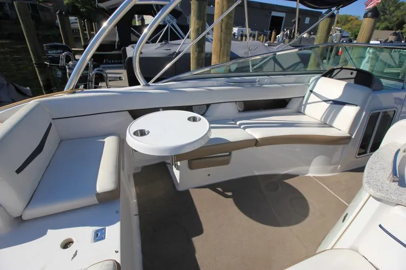 Slide: The Image of 2008 Four Winns 310 Horizon boat interior with seating and table, docked at marina. - 8