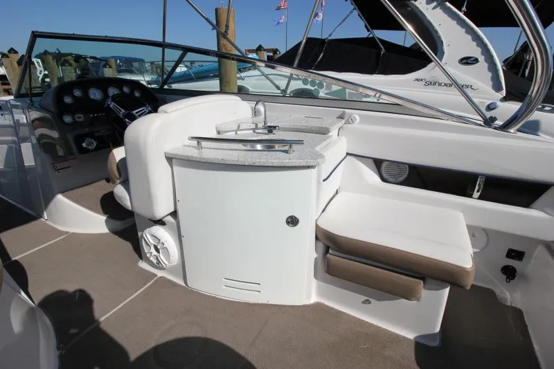 Slide: The Image of 2008 Four Winns 310 Horizon boat interior with helm, seating, and sink. - 9