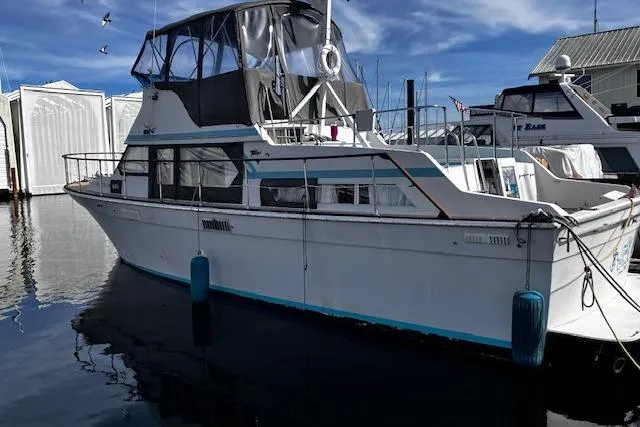 Slide: The Image of 1973 Tollycraft 40' Aft Cabin boat docked at marina with blue fenders. - 0