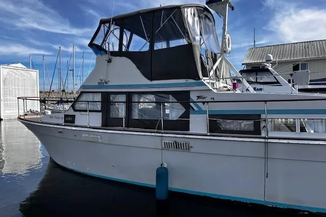 Slide: The Image of 1973 Tollycraft 40' Aft Cabin yacht docked at marina under blue sky. - 1