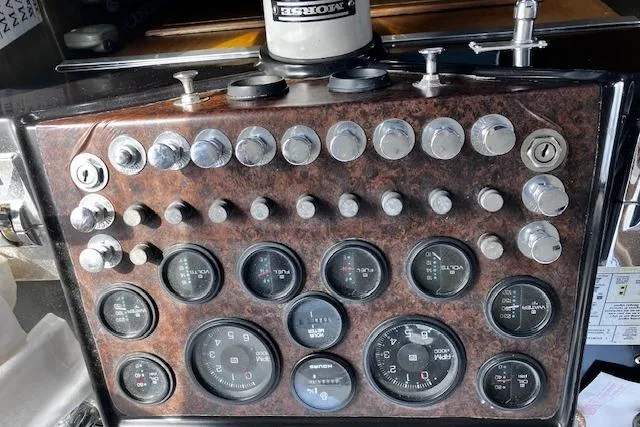 Slide: The Image of 1973 Tollycraft 40' Aft Cabin dashboard with gauges and controls, featuring a classic design. - 12