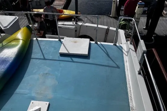 Slide: The Image of 1973 Tollycraft 40' Aft Cabin boat deck with colorful kayak, docked at marina. - 5