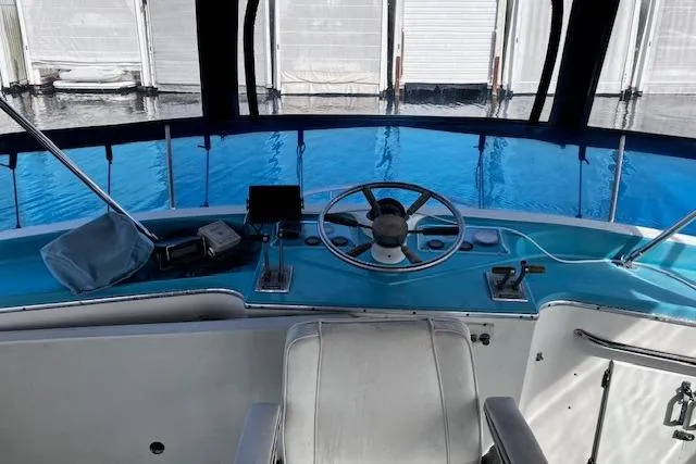 Slide: The Image of 1973 Tollycraft 40' Aft Cabin helm with steering wheel and navigation equipment. - 6