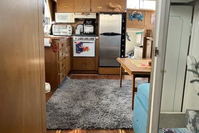 Slide: The Image of Interior of a 1973 Tollycraft 40' Aft Cabin with kitchen and cozy decor. - 9