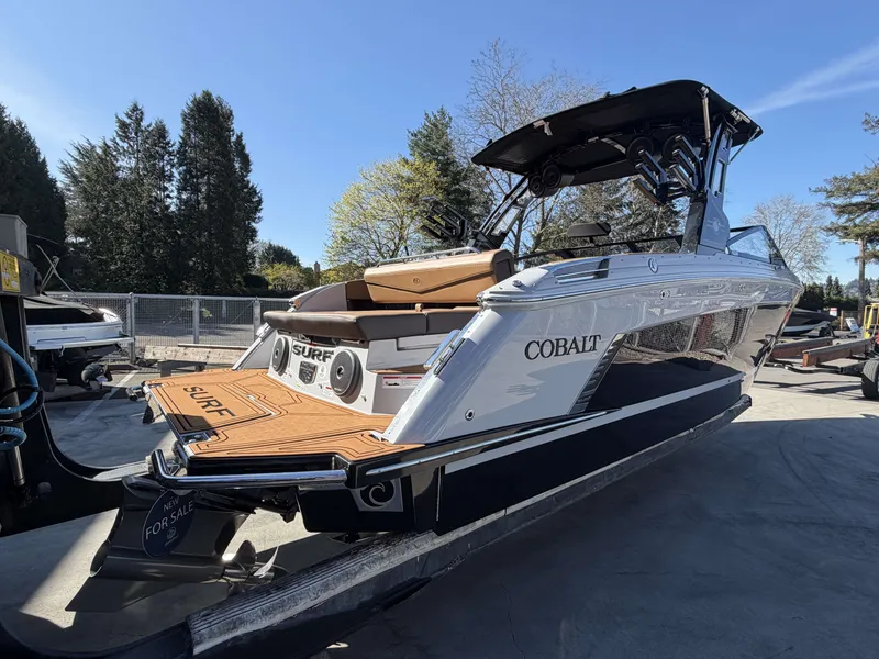 Slide: The Image of 2026 Cobalt R8 Surf boat on a trailer outdoors. - 5