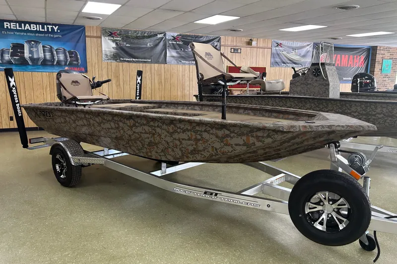 Slide: The Image of 2026 Xpress HD16DB boat with camouflage design on display in showroom. - 1