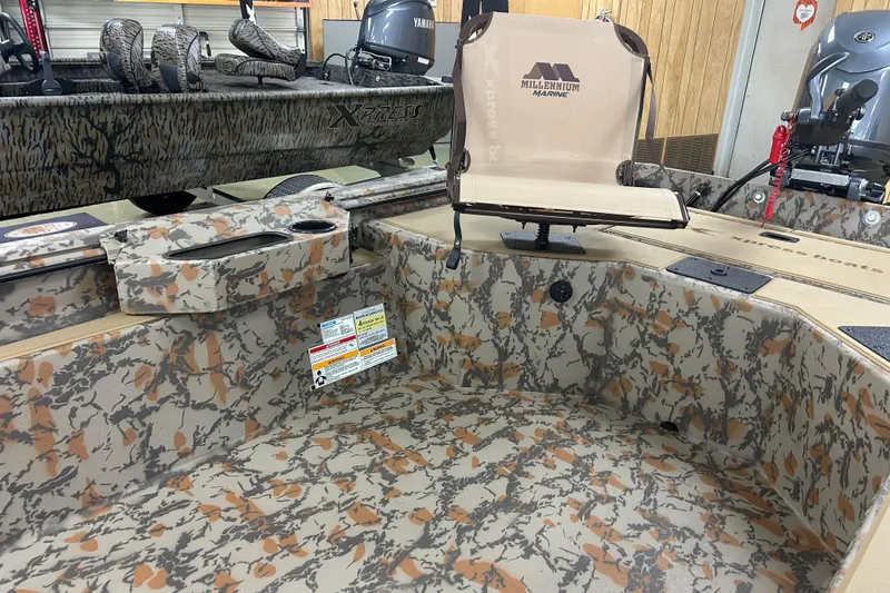 Slide: The Image of 2026 Xpress HD16DB boat interior with camouflage design and Millennium Marine seat. - 5