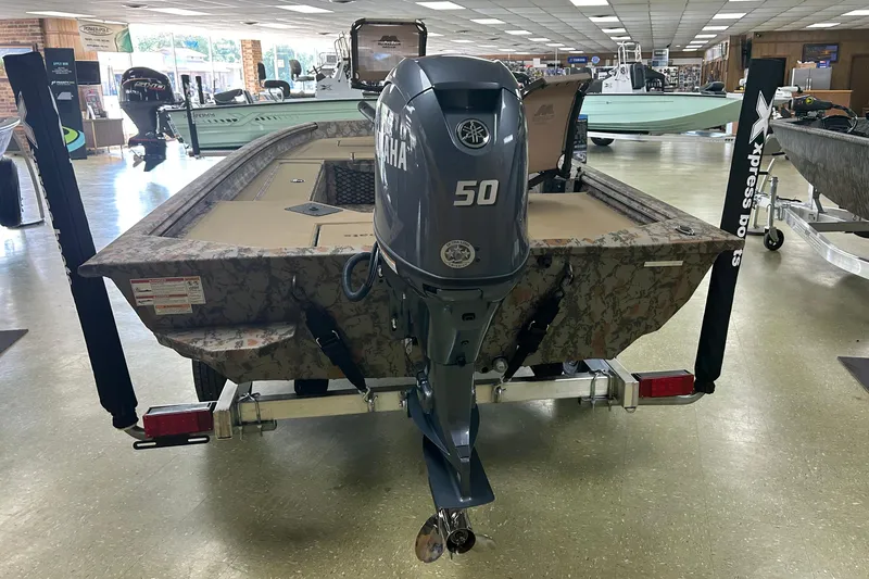 Slide: The Image of 2026 Xpress HD16DB boat with Yamaha 50 engine displayed indoors. - 7