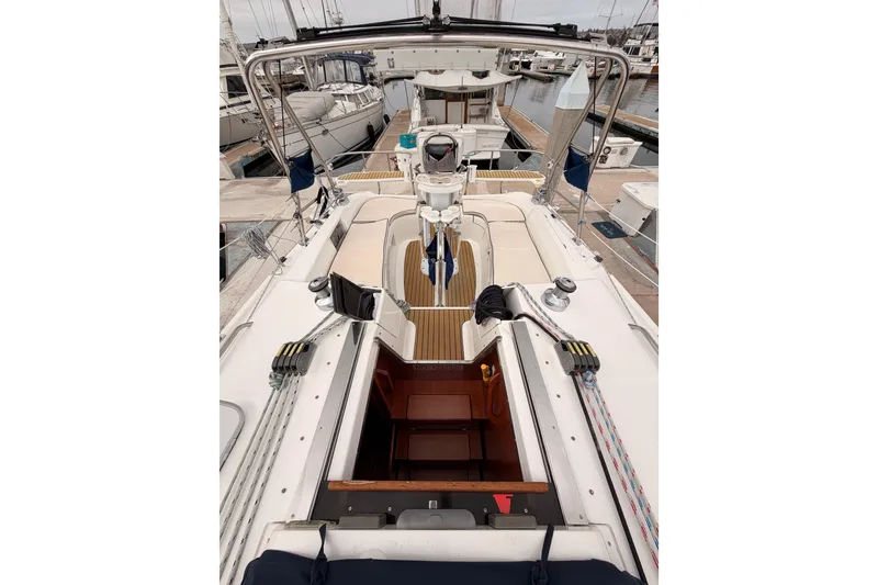 Slide: The Image of 2009 Hunter 38 sailboat cockpit with open cabin, docked at marina. - 16