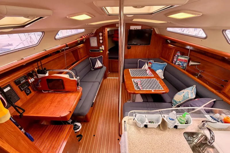 Slide: The Image of Luxurious 2009 Hunter 38 yacht interior with cozy seating and elegant wood finishes. - 21