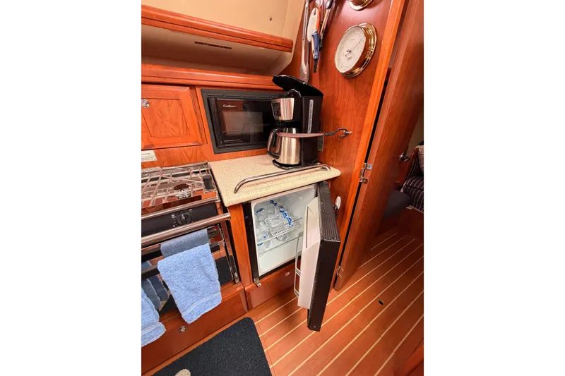Slide: The Image of 2009 Hunter 38 yacht kitchen with coffee maker, microwave, and open fridge. - 24