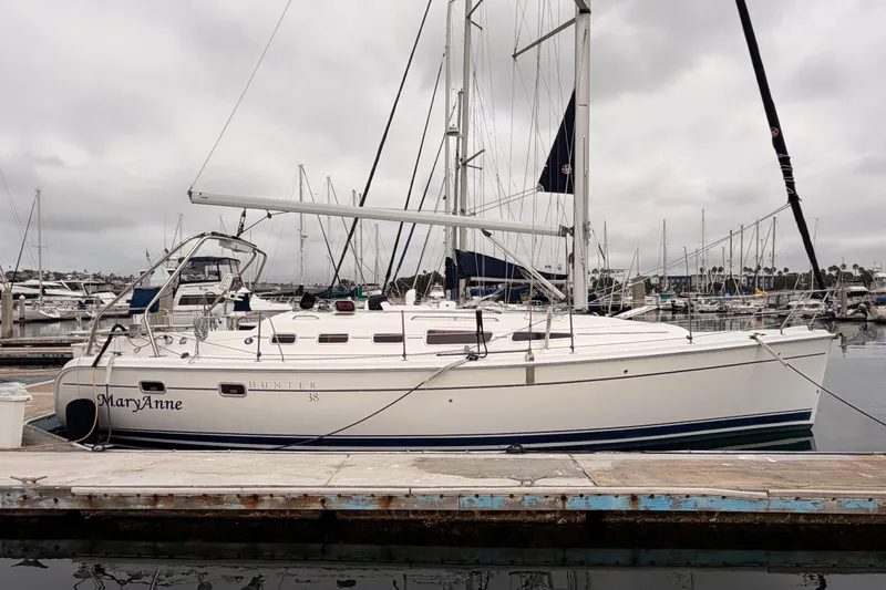 Slide: The Image of 2009 Hunter 38 sailboat docked at marina under cloudy skies. - 3
