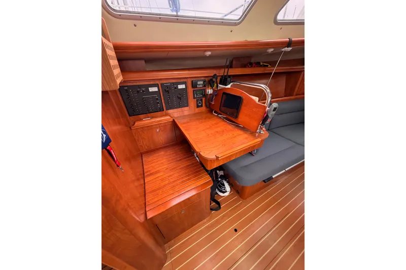 Slide: The Image of 2009 Hunter 38 yacht interior with navigation station and wooden cabinetry. - 31