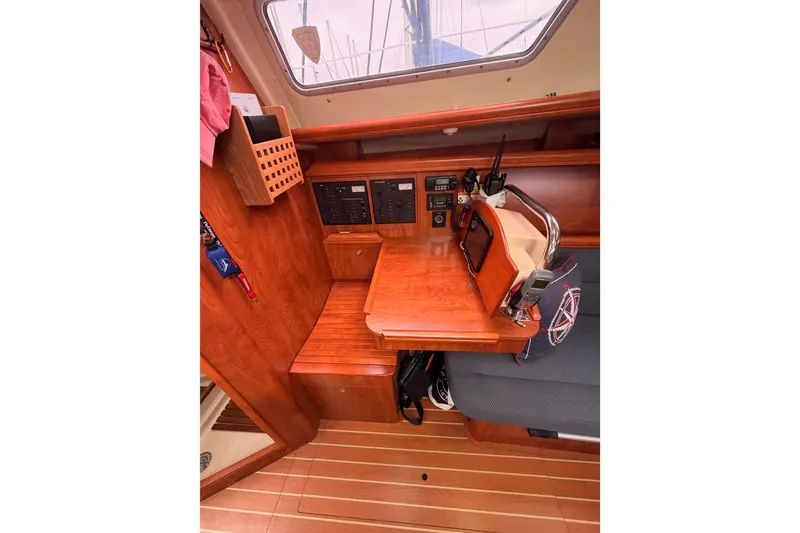 Slide: The Image of 2009 Hunter 38 sailboat interior with navigation station and wooden cabinetry. - 32