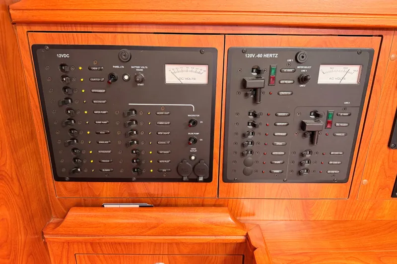 Slide: The Image of Electrical control panel on a 2009 Hunter 38 yacht, featuring 12VDC and 120V-60 Hertz systems. - 33