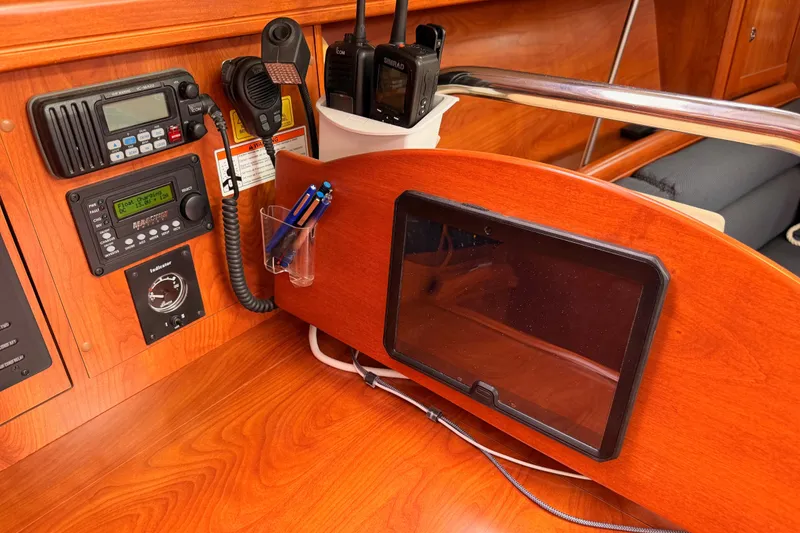 Slide: The Image of Navigation station on a 2009 Hunter 38 sailboat with communication equipment and tablet holder. - 34