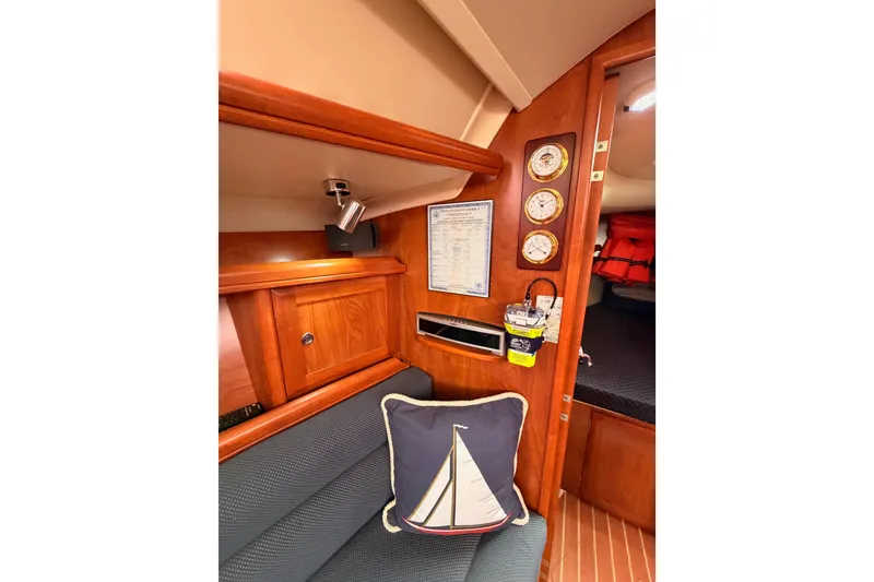 Slide: The Image of Interior of 2009 Hunter 38 sailboat with nautical decor and wooden cabinetry. - 38