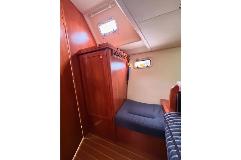 Slide: The Image of 2009 Hunter 38 yacht interior cabin with wooden cabinetry and cozy seating. - 48