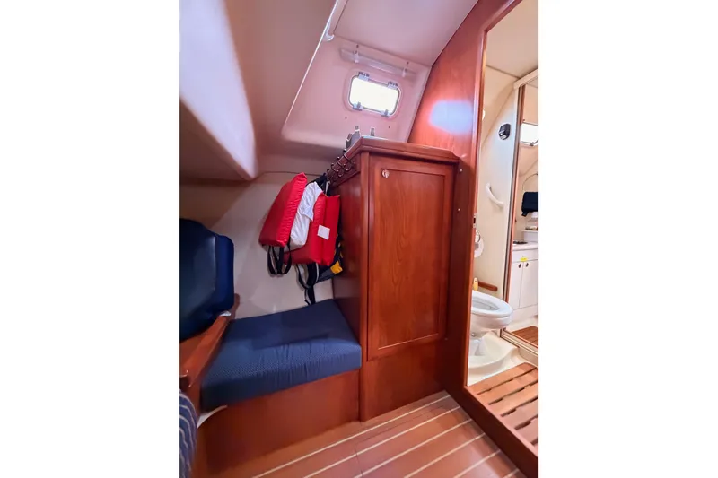 Slide: The Image of Interior of 2009 Hunter 38 sailboat with seating, storage, and bathroom area. - 50