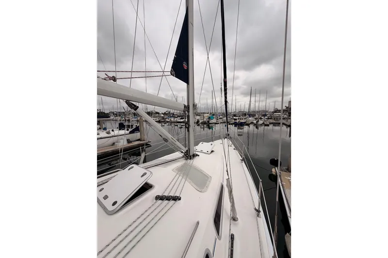 Slide: The Image of 2009 Hunter 38 sailboat docked in a marina under overcast skies. - 9