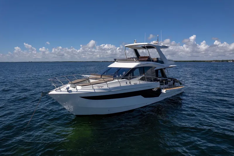 Slide: The Image of 2021 Galeon 500 Fly yacht on open water under clear blue sky. - 10