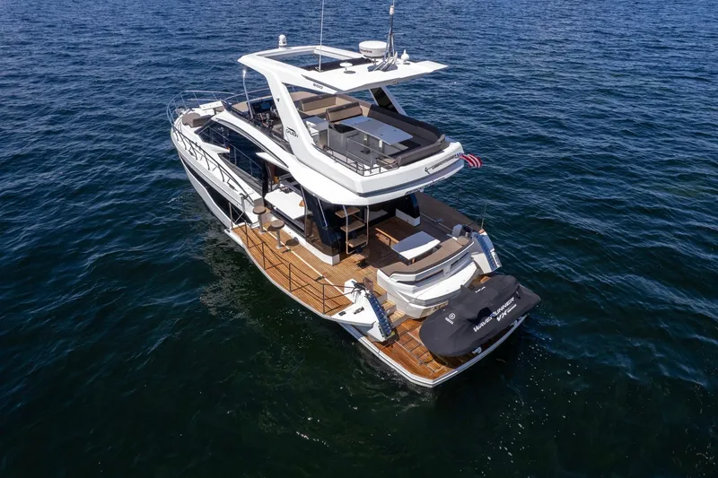 Slide: The Image of 2021 Galeon 500 Fly yacht cruising on open water, showcasing luxurious design and spacious deck. - 14