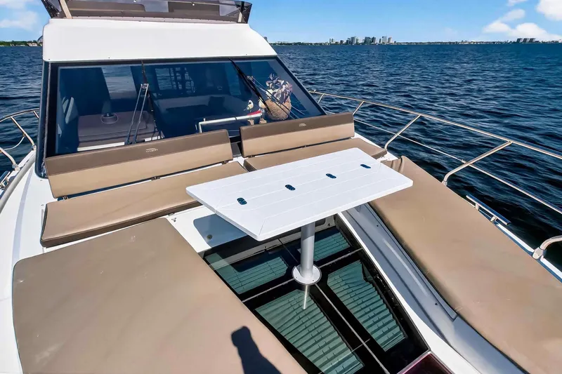 Slide: The Image of 2021 Galeon 500 Fly yacht with sunbathing area and table on open water. - 27