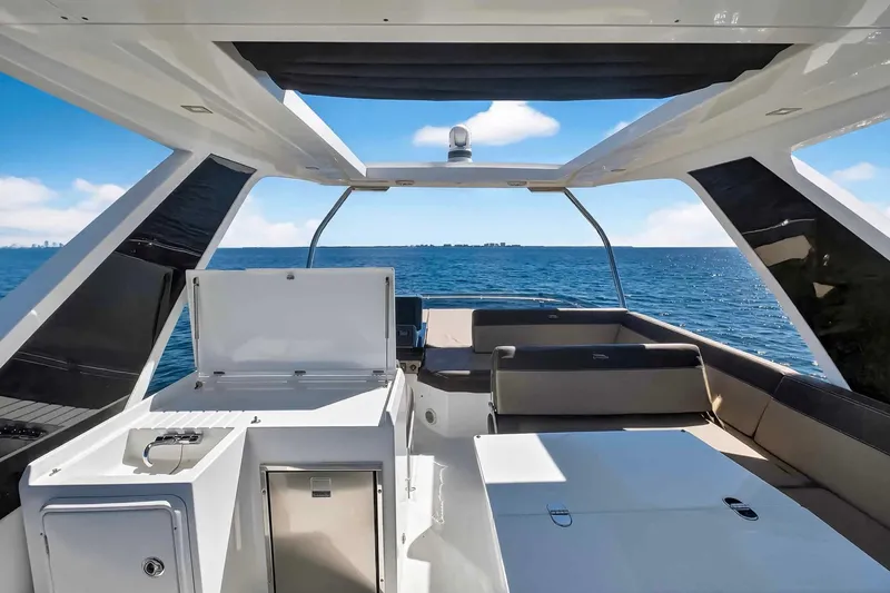 Slide: The Image of 2021 Galeon 500 Fly yacht interior with ocean view, featuring sleek design and spacious seating. - 32