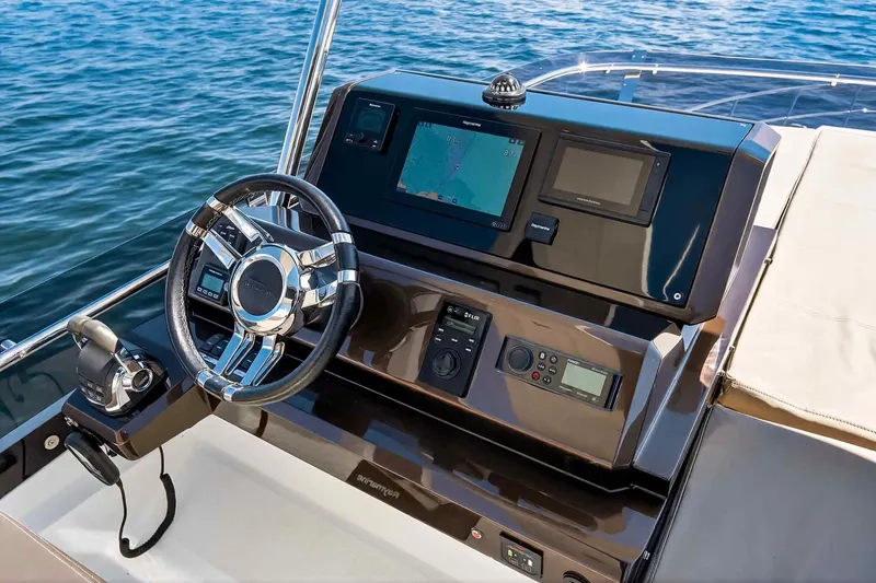 Slide: The Image of Helm of 2021 Galeon 500 Fly yacht with navigation controls and steering wheel. - 33