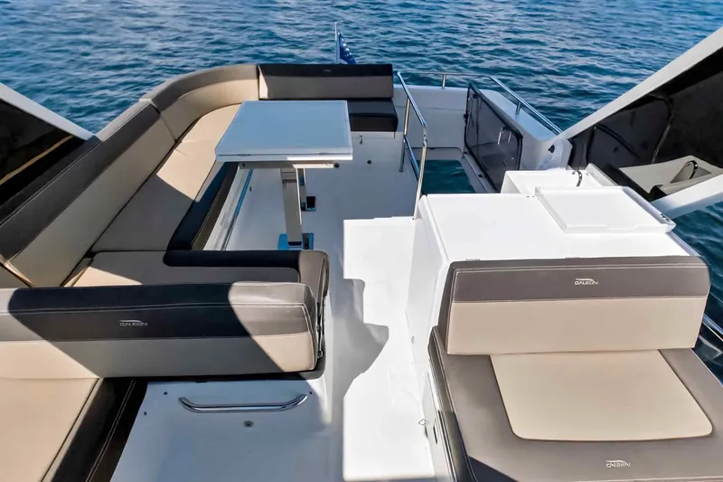 Slide: The Image of Luxurious 2021 Galeon 500 Fly yacht deck with elegant seating and table, overlooking the ocean. - 40