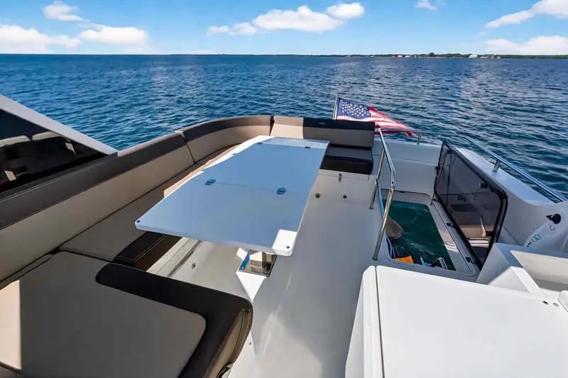 Slide: The Image of Luxurious 2021 Galeon 500 Fly yacht deck with seating, table, and ocean view. - 42