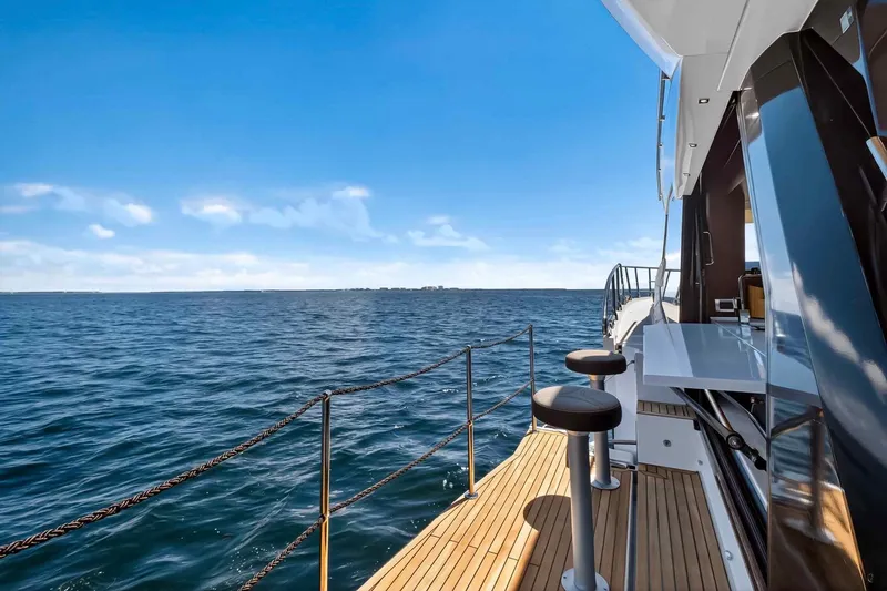 Slide: The Image of 2021 Galeon 500 Fly yacht deck with ocean view and clear blue sky. - 48
