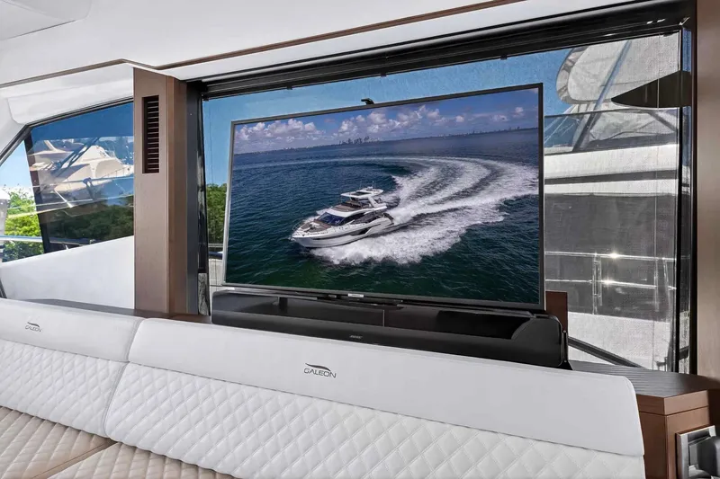 Slide: The Image of Luxurious interior of 2021 Galeon 500 Fly yacht with large TV and elegant seating. - 49