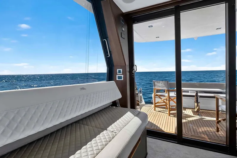 Slide: The Image of Luxurious interior of 2021 Galeon 500 Fly yacht with ocean view through glass doors. - 54