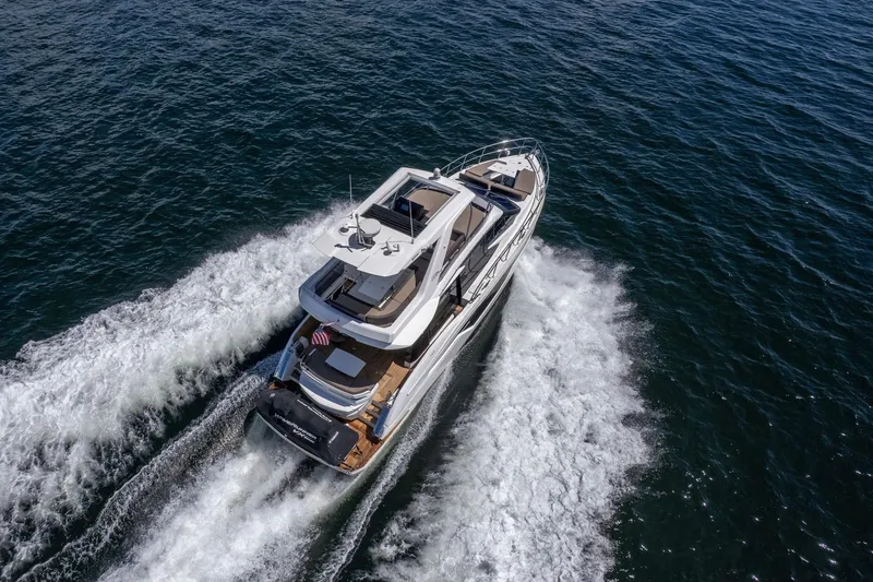 Slide: The Image of Aerial view of 2021 Galeon 500 Fly yacht cruising on open water. - 6