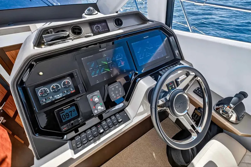 Slide: The Image of Cockpit of 2021 Galeon 500 Fly yacht with advanced navigation controls and steering wheel. - 65