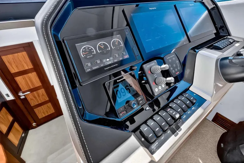 Slide: The Image of Control panel of 2021 Galeon 500 Fly yacht with advanced navigation displays and controls. - 66