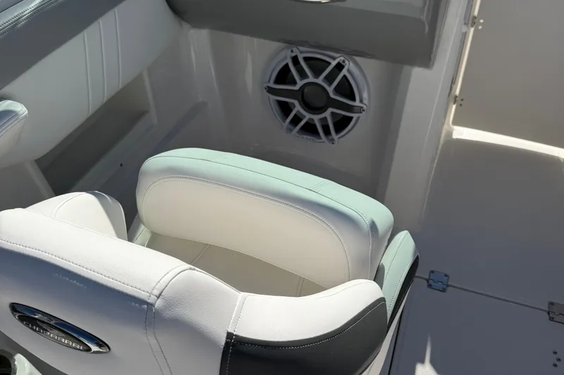 Slide: The Image of 2024 Chaparral 23 SSi OB boat interior with cushioned seating and speaker system. - 11