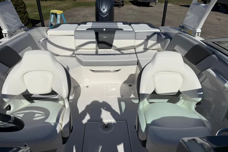 Slide: The Image of 2024 Chaparral 23 SSi OB boat interior with white seating and modern design. - 12