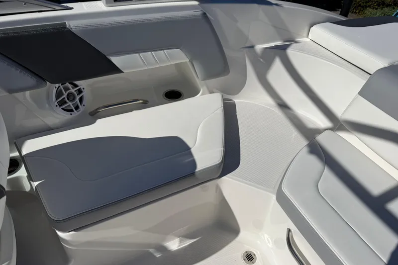 Slide: The Image of 2024 Chaparral 23 SSi OB boat interior with white seating and speaker. - 13