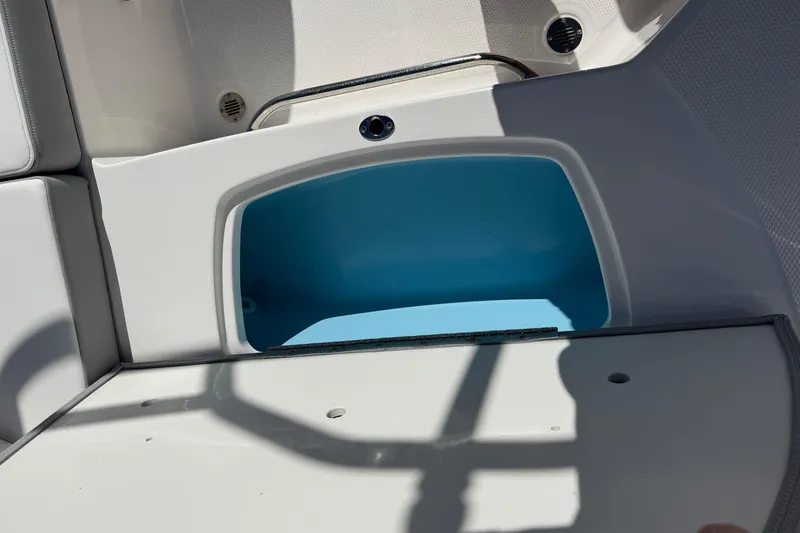 Slide: The Image of 2024 Chaparral 23 SSi OB boat storage compartment with blue interior. - 15