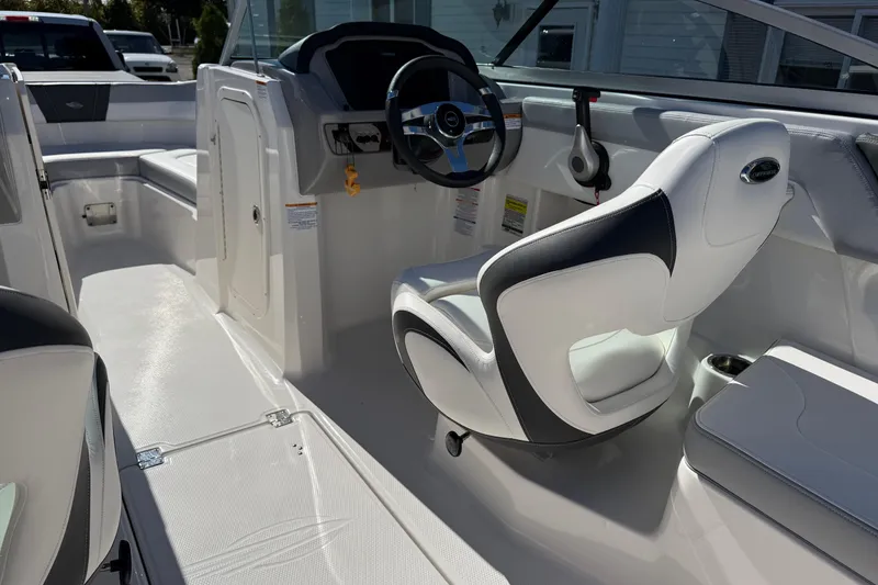 Slide: The Image of 2024 Chaparral 23 SSi OB boat interior with white seating and steering console. - 18