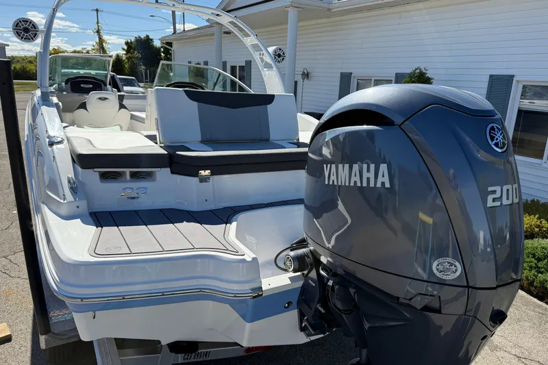 Slide: The Image of 2024 Chaparral 23 SSi OB boat with Yamaha 200 outboard motor, docked outdoors. - 20