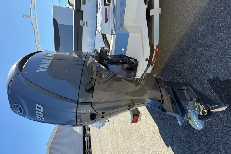 Slide: The Image of 2024 Chaparral 23 SSi OB with Yamaha 200 outboard motor, parked on pavement. - 22